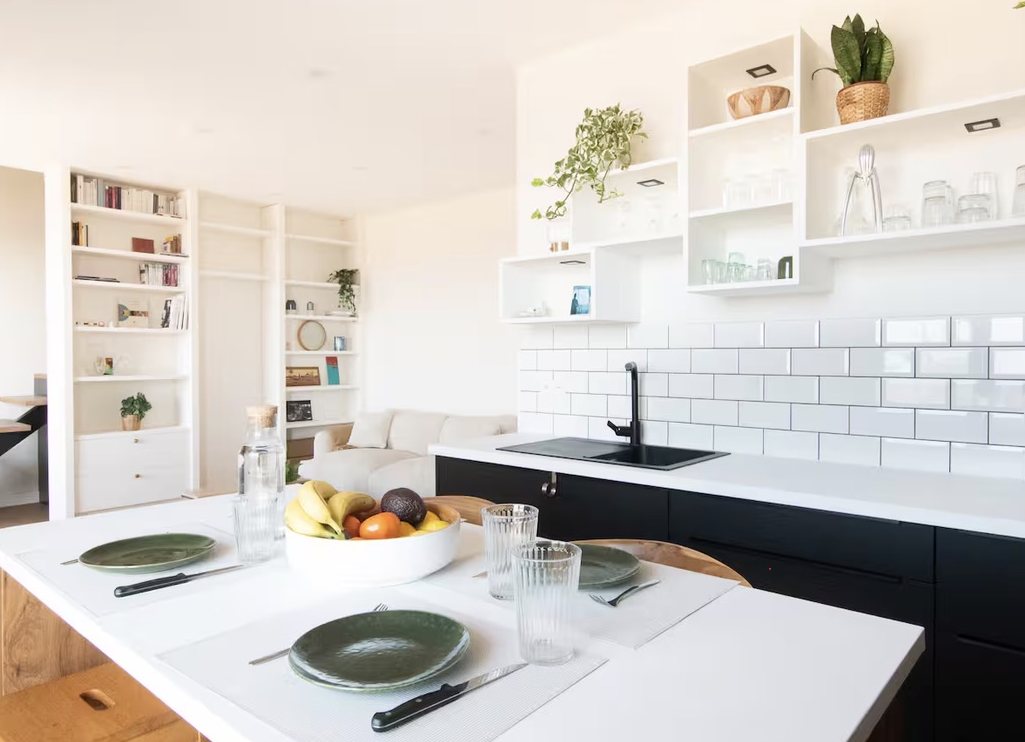 Îlot de cuisine en bois et plan blanc, crédence en carreaux métro